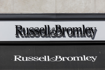 LONDON, UK - JULY 31th 2018: Russell and Bromley shoe shop store front branding on Oxford Street in...