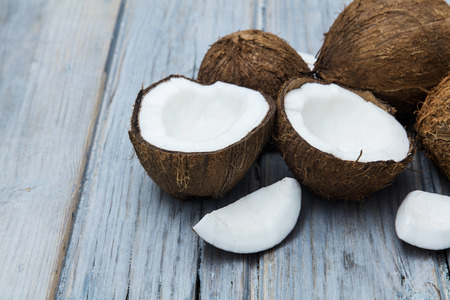 Coconuts on a rustic wooden background.