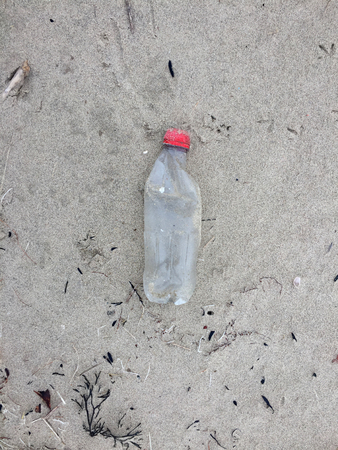 Plastic bottle waste on a sand beachの写真素材
