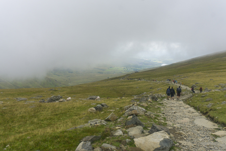 SNOWDONIA, WALES: AUGUST 14th 2018: Walkers make their way up to the summit of Mount Snowdon in North Wales.のeditorial素材