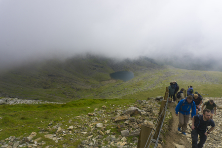 SNOWDONIA, WALES: AUGUST 14th 2018: Walkers make their way up to the summit of Mount Snowdon in North Wales.のeditorial素材
