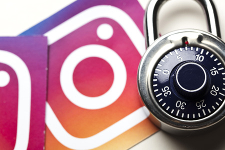 OXFORD, UK - AUGUST 22nd 2018: Instagram data security concept. Instagram logos printed onto paper with a combination padlockのeditorial素材