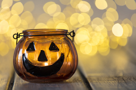 Halloween pumpkin lantern with bokeh fairy lights backgroundの写真素材
