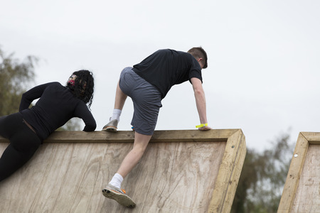 LONDON, UK - SEPTEMBER 8th 2018: Participants take part in a rough runner obstacle course race in...