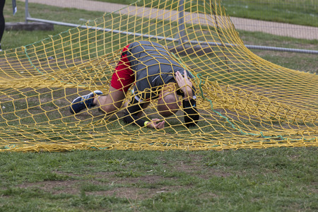LONDON, UK - SEPTEMBER 8th 2018: Participants take part in a rough runner obstacle course race in Londonのeditorial素材