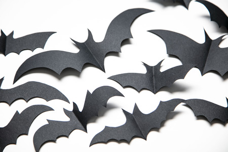 Halloween paper bat decorations on a white background.の写真素材