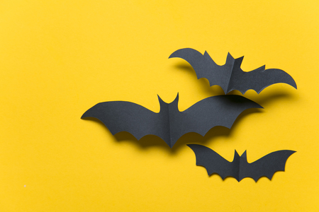 Halloween paper vampire bat decorations on an orange background.の写真素材