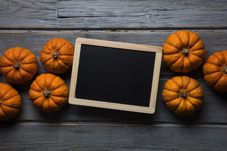 MIni pumpkins arranged on a rustic wooden backgroundの写真素材