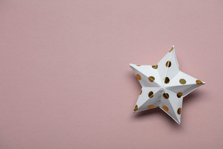 White and gold star decorations on a pastel pink. Seasonal festive backgroundの写真素材