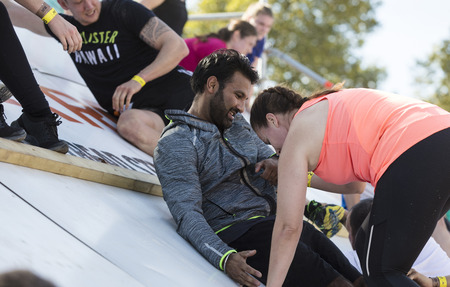 LONDON, UK - September 13th 2018: Participants take part in a Tough Mudder 5K obstacle race in London.のeditorial素材