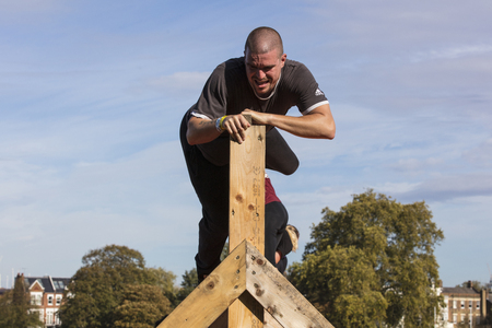 LONDON, UK - September 13th 2018: Participants take part in a Tough Mudder 5K obstacle race in London.のeditorial素材