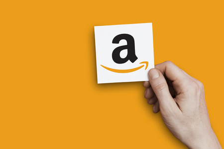LONDON, UK - October 30th 2018: Hand holding Amazon icon. Amazon is the largest internet retailer in...