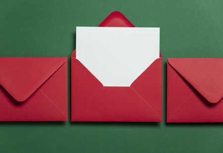 Blank white card with red paper envelope Christmas card template mock up.の写真素材