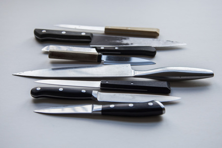 A variety of knives on a plain background. Knife crime conceptの写真素材