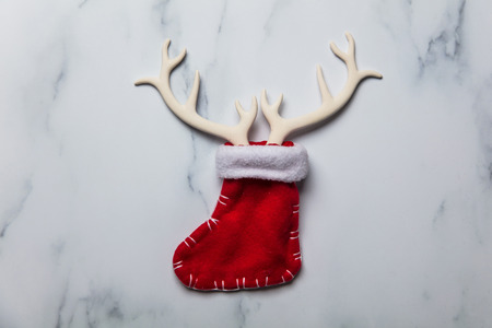 Christmas reindeer antlers and stocking on a marble backgroundの写真素材