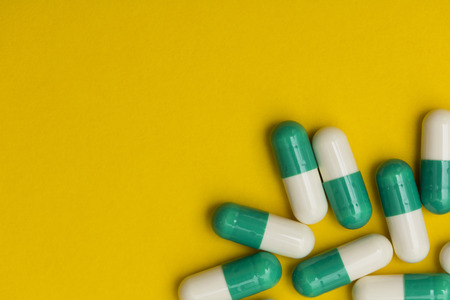 Prescription antibiotic drug medication pills on a bright colourful background. Health care conceptの写真素材