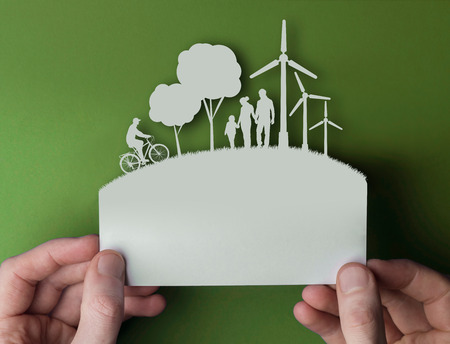 Green environmental paper background with wind turbines, trees and peopleの写真素材