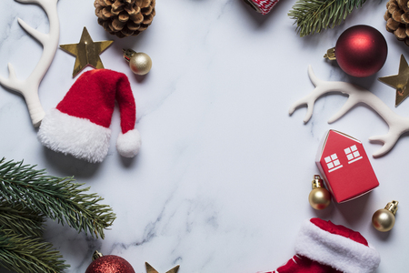 Christmas compostion, baubles, santa hat, christmas tree on a marble backgroundの写真素材