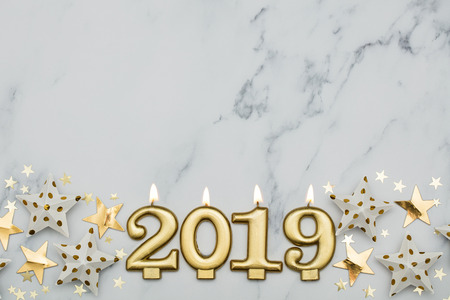 Happy new year 2019 with gold stars on a marble background