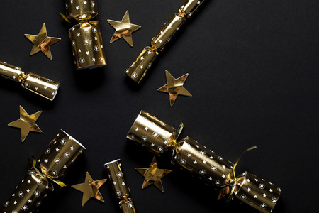 Gold festive Christmas crackers on a dark backgroundの写真素材