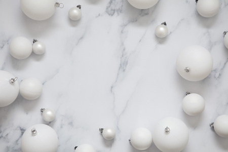 Christmas composition. white festive ball decorations on a marble backgroundの写真素材