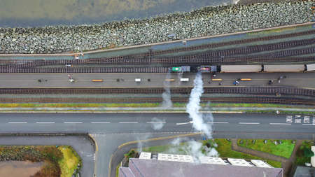 Aerial view of a vintage steam engine train with puffing smoke