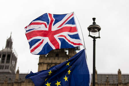 European Union and British Union Jack flag flying together. A symbol of the Brexit EU referendumの写真素材