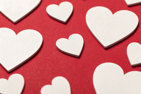 White valentine love hearts on a red background