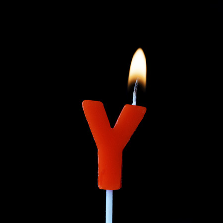 Letter Y celebration birthday candle against a black backgroundの写真素材