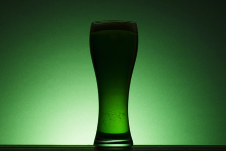 St Patrick's Day green beer silhouette against a green backgroundの写真素材