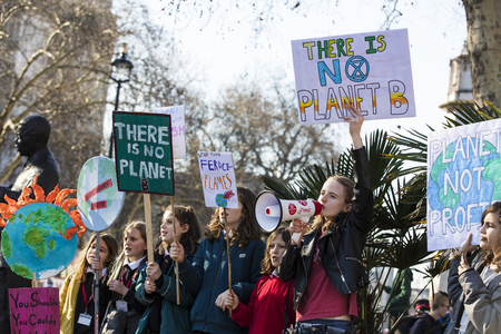 LONDON, UK - February 15, 2019: Protestors with banners at a Youth strike for climate march in...