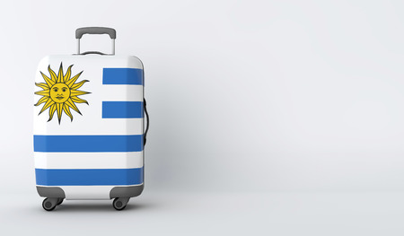 Travel suitcase with the flag of Uruguay. Holiday destination. 3D Renderの写真素材