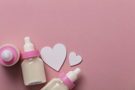 Baby bottle on a pastel pink background. New baby arrivalの写真素材