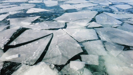 Arctic ice melting and cracking on the surface of the sea