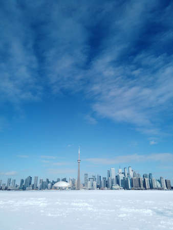 Toronto city skyline seen from toronto Islands over frozen lake Ontarioの写真素材
