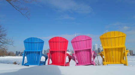 View of Toronto city skyline seen form Toronto Islands with colourful chairsの写真素材