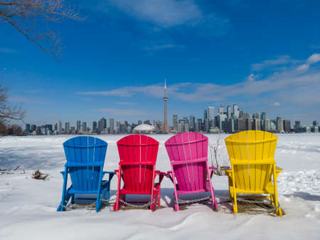 View of Toronto city skyline seen form Toronto Islands with colourful chairsの写真素材