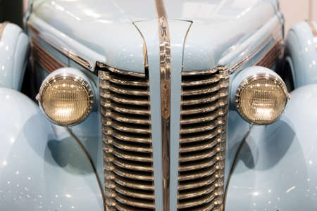 A close up of a classic vintage car headlight