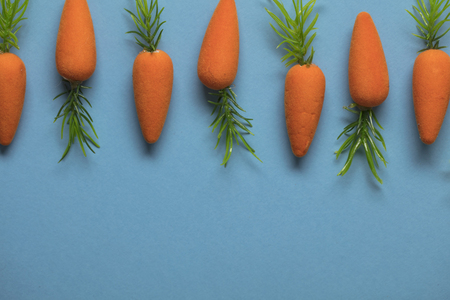 Easter bunny carrots on a blue backgroundの写真素材