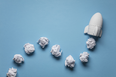 Business startup concept. Rocket taking off with crumpled paper trailの写真素材