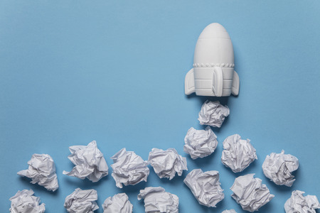 Business startup concept. Rocket taking off with crumpled paper trailの写真素材