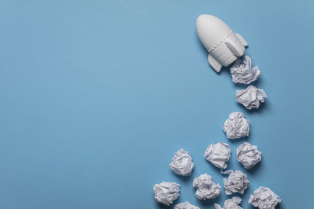 Business startup concept. Rocket taking off with crumpled paper trailの写真素材