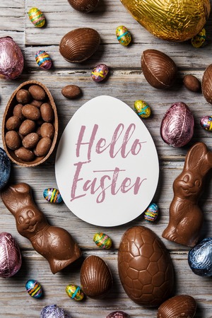 Chocolate easter eggs and bunnies on a rustic wooden backgroundの写真素材
