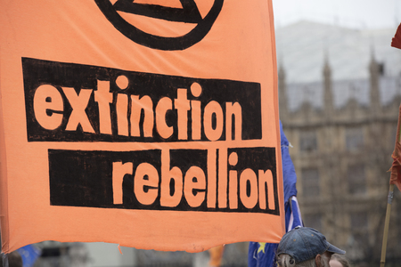 Protestors with Extinction Rebellion flags at a protest in Londonのeditorial素材