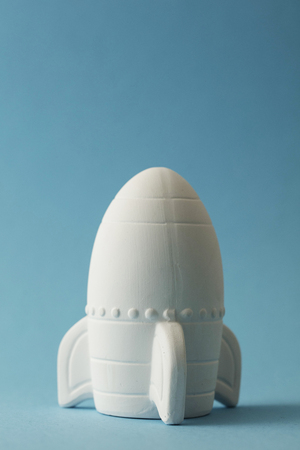 Business startup concept. Rocket ship against a blue backgroundの写真素材