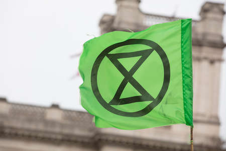 Extinction Rebellion flags being waved at a protest in Londonの写真素材