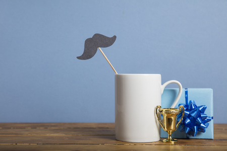 Fathers day composition with gifts, coffee mug and paper mustacheの写真素材