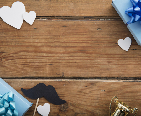 Father's day composition. Gift box with hearts and mustache on wooden backgroundの写真素材