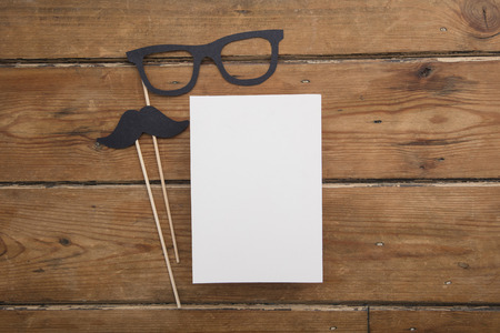 Fathers day blank card with paper mustache and glasses on sticksの写真素材