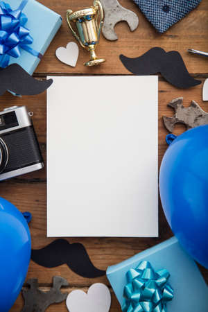 Fathers day blank white card composition with gifts, mustache, trophy, cameraの写真素材